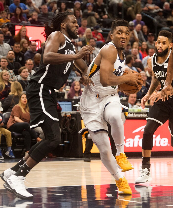 (Rick Egan  |  The Salt Lake Tribune)  Utah Jazz guard Donovan Mitchell (45) takes the ball inside,as Brooklyn Nets forward DeMarre Carroll (9) defends, in NBA action, Utah Jazz vs. Brooklyn Nets, in Salt Lake City, Saturday, November 11, 2017.