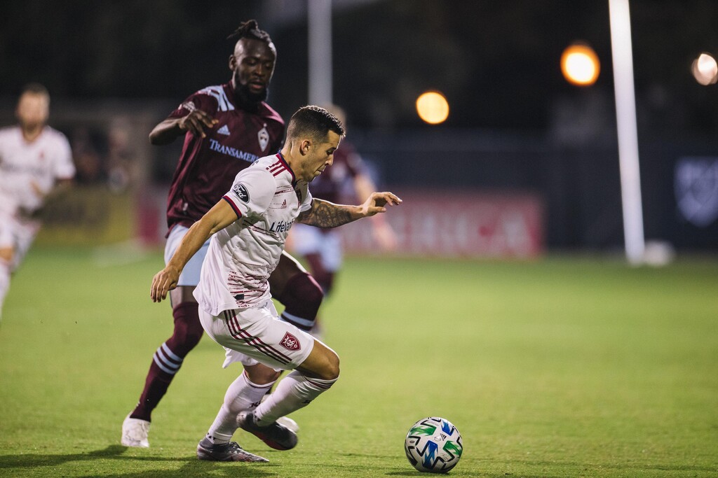 (Photo courtesy of Matthew Stith/Major League Soccer) Real Salt Lake defender Aaron Herrera dribbles against a Colorado Rapids defender during the 2-0 win over the Rapids on Sunday, July 12, 2020.