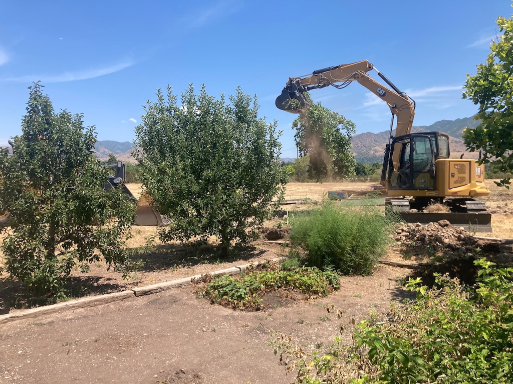 (Tony Semerad | The Salt Lake Tribune) Public works crews with South Salt Lake moved Tuesday to remove a series of gardens and trees behind homes along Parkway Avenue in Salt Lake City's Highland Park. The suburban city says it is securing a piece of property it owns behind the homes.