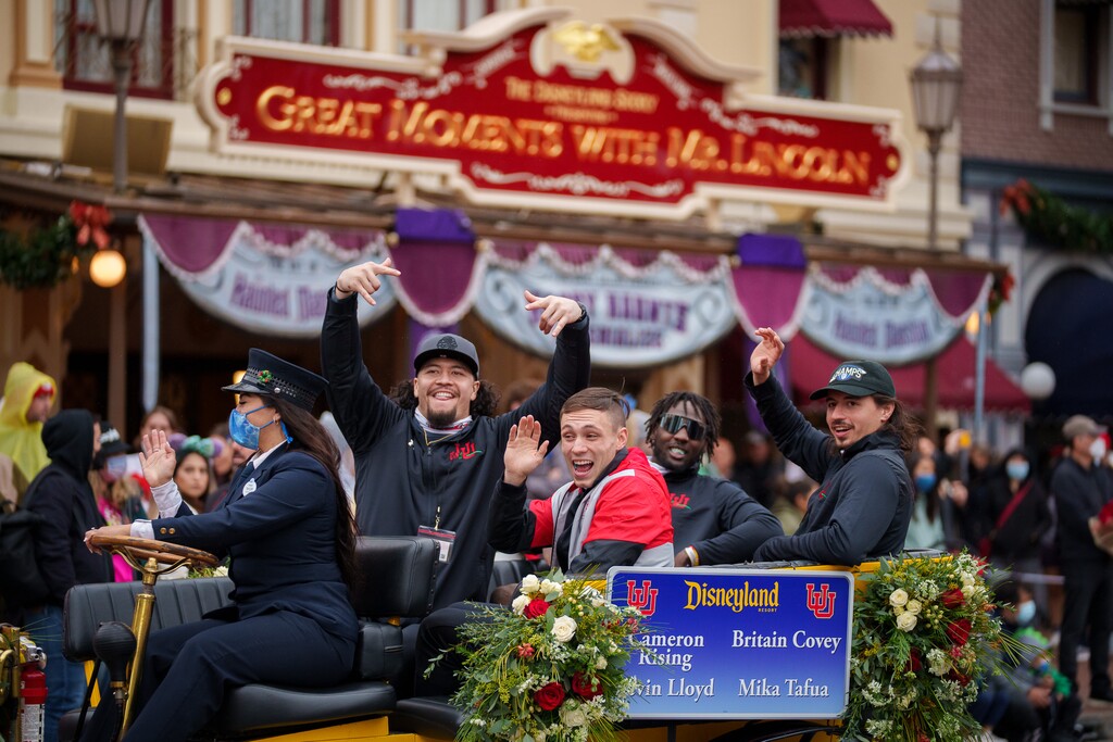 (Trent Nelson  |  The Salt Lake Tribune) Mika Tafua, Devin Lloyd, Britain Covey and Cameron Rising ride down Disneyland's Main Street during the Rose Bowl Game Cavalcade in Anaheim, Calif., on Monday, Dec. 27, 2021.