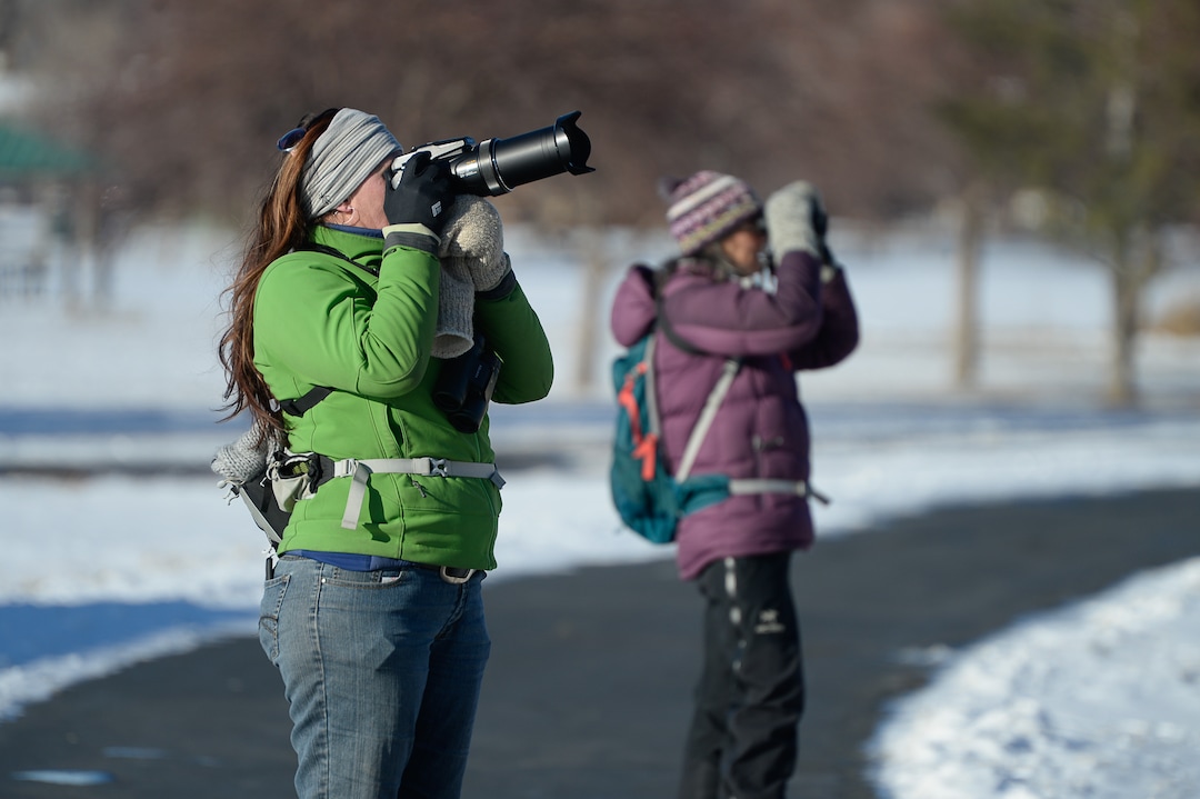 (Francisco Kjolseth  |  The Salt Lake Tribune)  Connie Misket, left, uses a long telephoto lens to photograph birds as she and Vivian Schneggenburger join other Audubon members to walk a long stretch of the Jordan River from Bangerter Highway to South Jordan on New Year's Day counting birds as part of the annual survey, now its 119th year, done by multiple members across Utah.