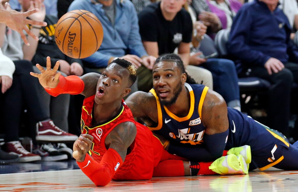 Atlanta Hawks guard Dennis Schroder, left, passes the ball as Utah Jazz forward Jae Crowder, right, defends in the second half during an NBA basketball game Tuesday, March 20, 2018, in Salt Lake City. (AP Photo/Rick Bowmer)