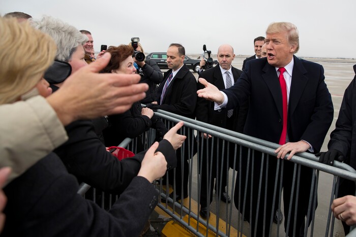 President Donald Trump shakes hands after arriving at Salt Lake City International Airport, Monday, Dec. 4, 2017, in Salt Lake City. (AP Photo/Evan Vucci)