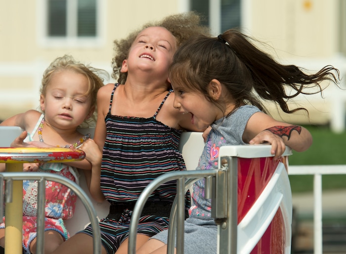 (Rick Egan  |  The Salt Lake Tribune)    Ayla Apple, 3 Kailyn Apple, 5, and Aliyah Bain, 4, spin around on the Tubs o' Fun, at the Davis County Fair in Farmington, Saturday, Aug. 18, 2018.