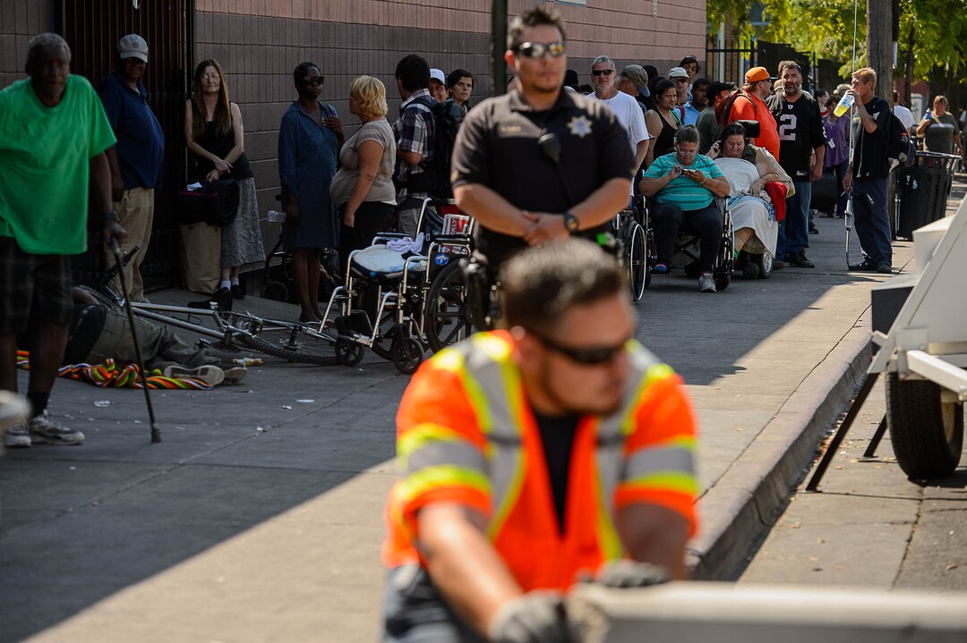 (Trent Nelson | The Salt Lake Tribune)  As police look on, workers install barriers on Rio Grande in Salt Lake City to prevent auto traffic in hopes of stopping the drug traffic around the area, Friday September 1, 2017.