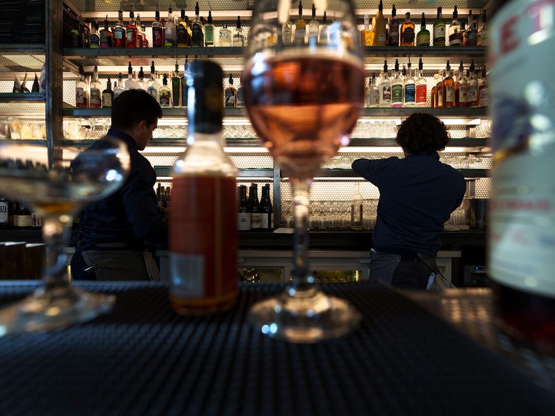 (Leah Hogsten | The Salt Lake Tribune) l-r Emigration Cafe bartenders Aaron Jeffers and Gabe Spiegel fill drink orders opening night, Wednesday, April 27, 2022. Emigration Cafe's menu features Roman style wood fired pizza, salads, sandwiches and mains.