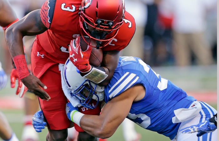 BYU defensive back Eric Takenaka, right, tackles Utah quarterback Troy Williams (3) in the first half of an NCAA college football game Saturday, Sept. 10, 2016, in Salt Lake City. (AP Photo/Rick Bowmer)
