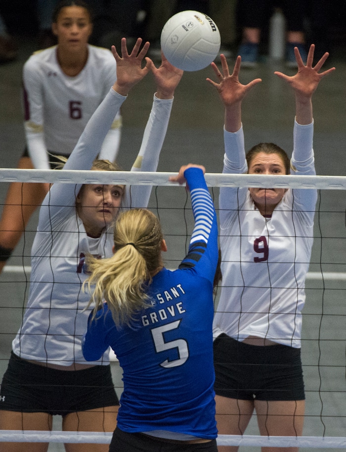 (Rick Egan  |  The Salt Lake Tribune)   Pleasant Grove Vikings Heather Gneiting (5) hits the ball, as Lone Peak Knights  Kennedi Boyd (10) and Madelyn Robinson (9) defend, in the 6A volleyball championship action, Pleasant Grove vs. Lone Peak, at Utah Valley University, Saturday, November 4, 2017.