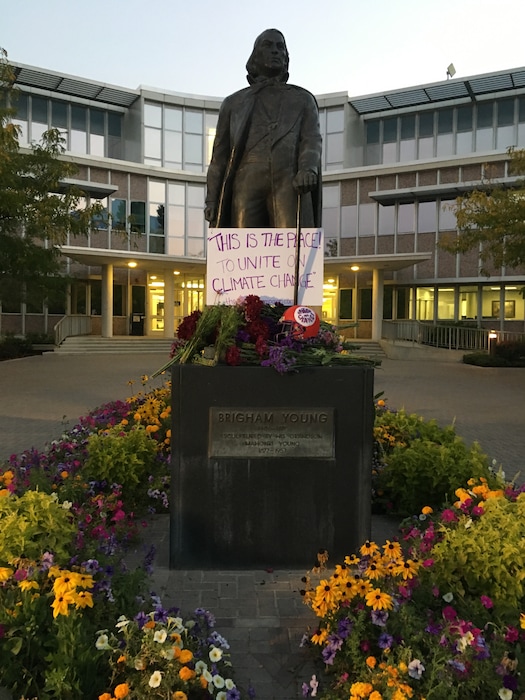 (Courtesy of Nicholas Huey, The Climate Campaign) Students from the University of Utah adorned a statute of Brigham Young on BYU's campus with a custom-painted football helmet and a climate change slogan. The prank was the last round of a series of stunts students from both schools are pulling together to call for bipartisan action on climate change.