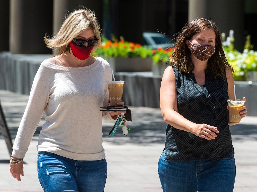 (Rick Egan  |  The Salt Lake Tribune) Melissa Fryer and Naarah Kristensen wear masks as they cross the street in downtown Salt Lake City, on
Wednesday, July 29, 2020.
