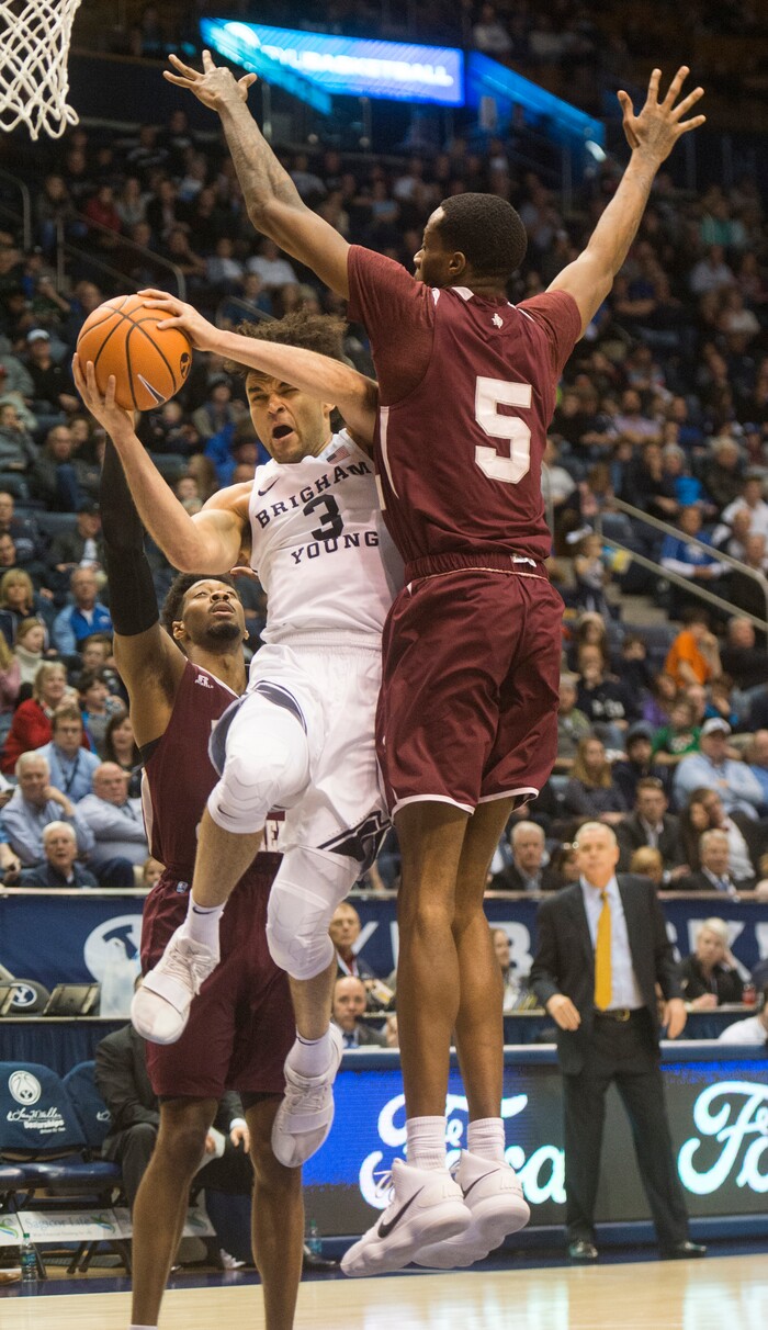 (Rick Egan  |  The Salt Lake Tribune)   Brigham Young Cougars guard Elijah Bryant (3) takes the ball to the hoop, as Texas Southern Tigers center Trayvon Reed (5) defends, in basketball action, Brigham Young Cougars vs Texas Southern Tigers, at the Marriott Center in Provo, Saturday, December 23, 2017.