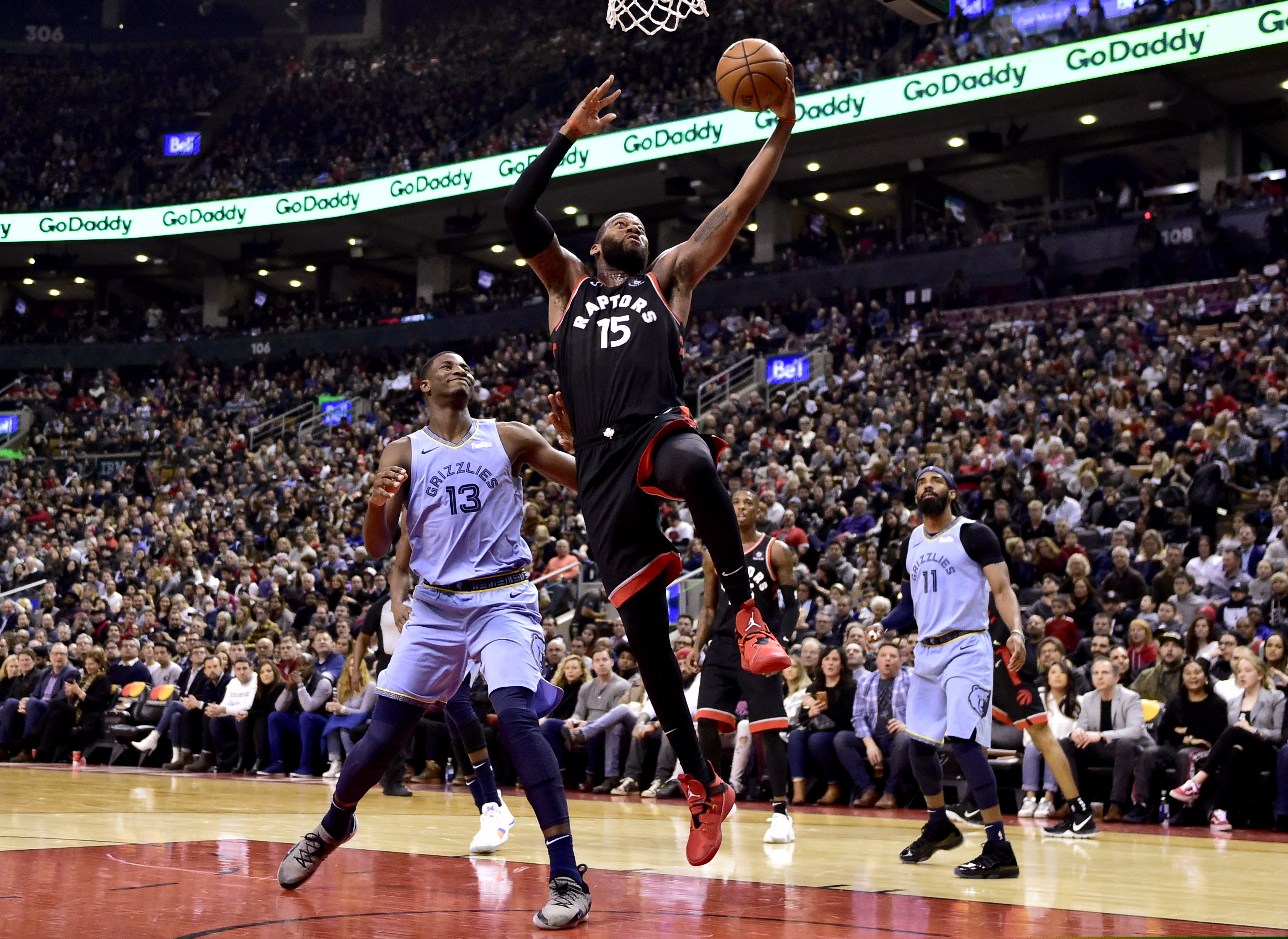 Toronto Raptors center Greg Monroe (15) drives to the net as Memphis Grizzlies forward Jaren Jackson Jr. (13) looks on during the first half of an NBA basketball game in Toronto on Saturday, Jan. 19, 2019. (Frank Gunn/The Canadian Press via AP)