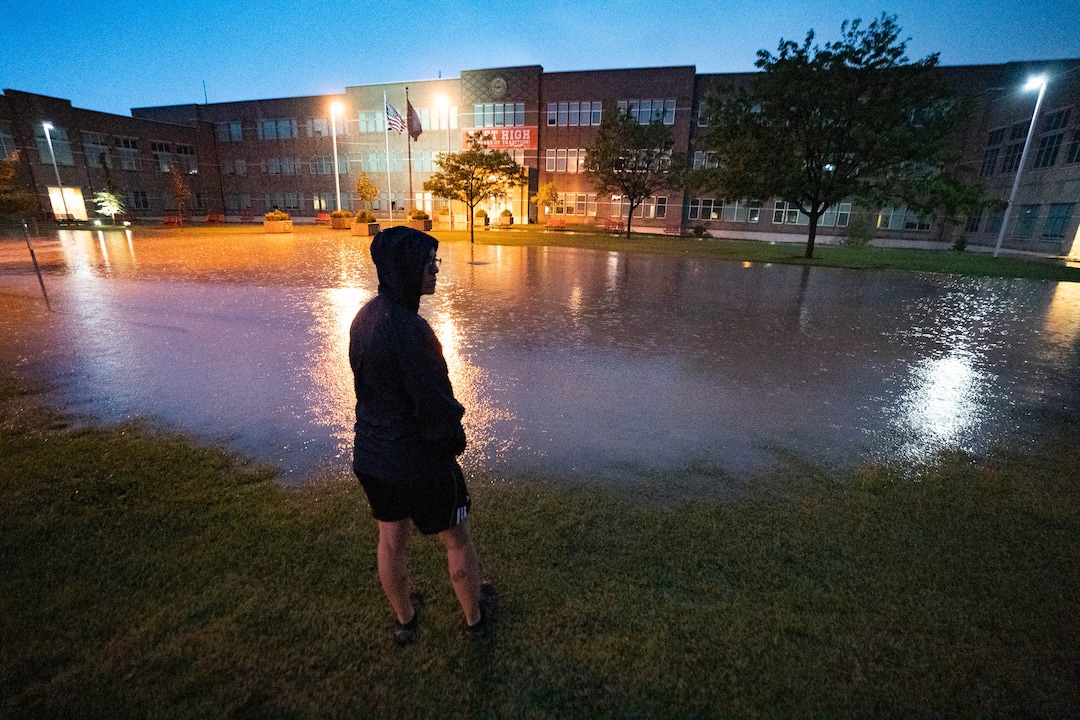(Francisco Kjolseth | The Salt Lake Tribune) Jessica Miller checks out East High, severely flooded following a torrential downpour on Sunday, Aug. 1, 2021.