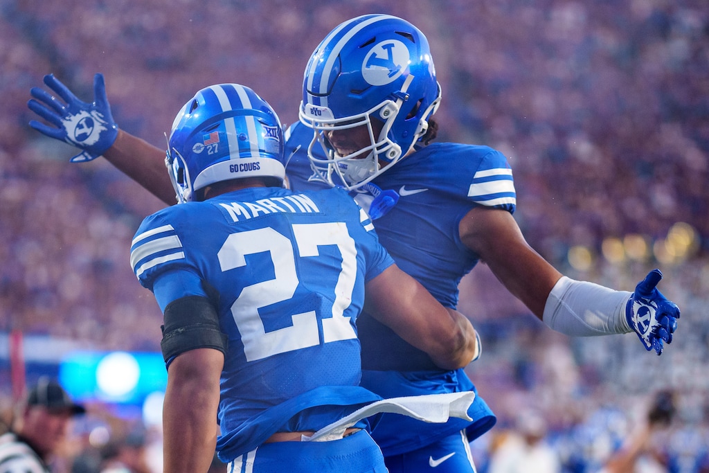 (Trent Nelson | The Salt Lake Tribune) Brigham Young Cougars running back LJ Martin (27) and Brigham Young Cougars tight end Keanu Hill (1) celebrate a touchdown as BYU hosts Southern Illinois, NCAA football in Provo on Saturday, Aug. 31, 2024.