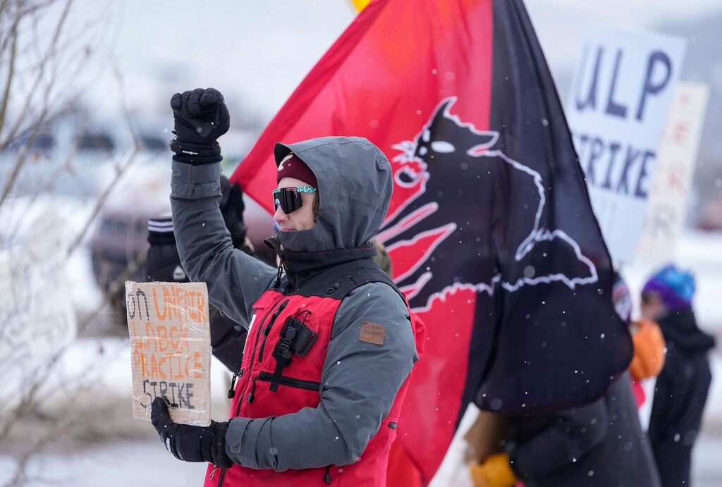 (Francisco Kjolseth | The Salt Lake Tribune) Park City ski patroller Mike Reilly, alongside a sabo cat flag, a symbol of labor organizing, joins other patrollers as they officially go on strike early Friday, Dec. 27, 2024. Citing unfair labor practices and marking the latest chapter in the union’s negotiations with Park City Mountain and its owner, Vail Resorts the patrollers took up the fight at several locations in Park City.