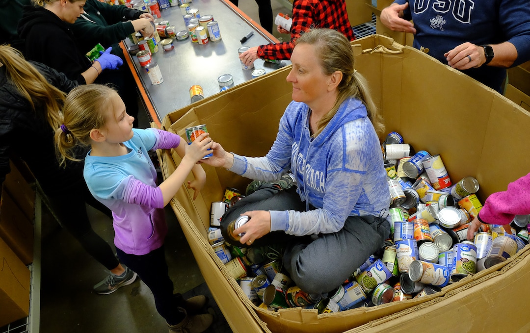 (Francisco Kjolseth  |  The Salt Lake Tribune) Tiffany Vaughn and her daughter Emily, 6, of Park City help out at The Utah Food Bank on Saturday, March 14, 2020, after hearing they are hurting for volunteers, since groups that normally volunteer canceled after the order of mass gatherings due to the coronavirus outbreak.