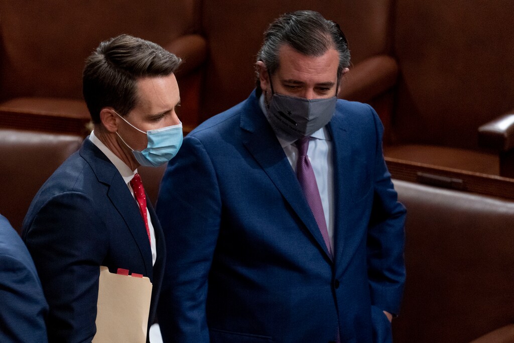 (Andrew Harnik | AP photo)
Sen. Josh Hawley, R-Mo., left, and Sen. Ted Cruz, R-Texas, right, speak after Republicans objected to certifying the Electoral College votes from Arizona, during a joint session of the House and Senate to confirm the electoral votes cast in November's election, at the Capitol, Wednesday.