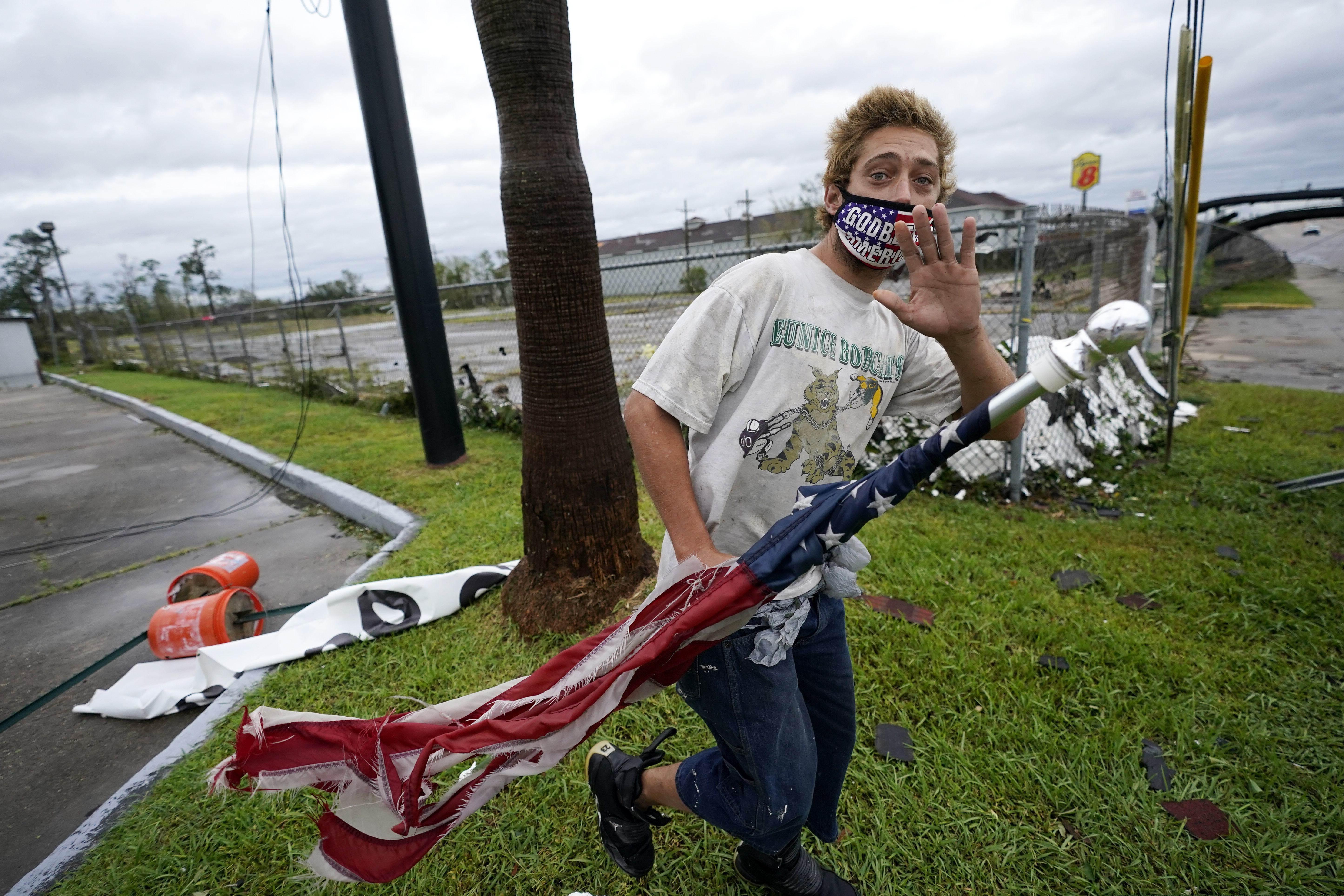 Dustin Amos walks near debris at a gas station on Thursday, Aug. 27, 2020, in Lake Charles, La., after Hurricane Laura moved through the state. (AP Photo/Gerald Herbert)