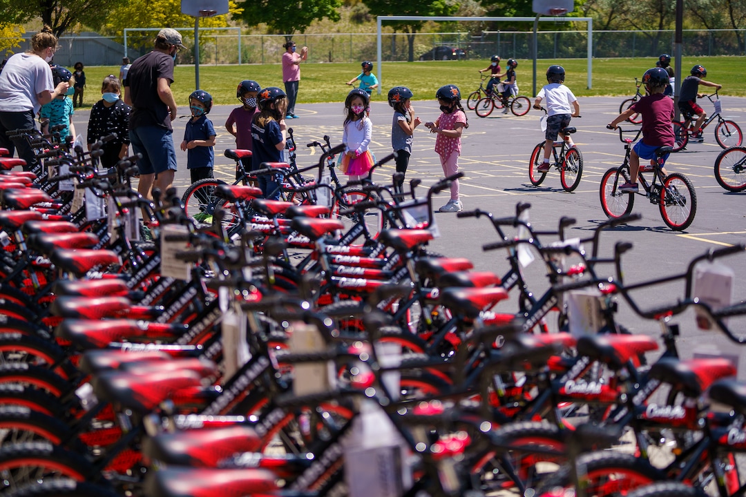 (Trent Nelson  |  The Salt Lake Tribune) Volunteers with Can’d Aid, a non-profit, hand out sixty bikes to 1st grade students at Mary W. Jackson Elementary in Salt Lake City on Thursday, May 13, 2021.