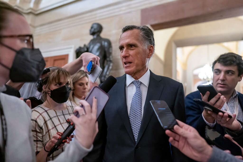 (J. Scott Applewhite | AP) Sen. Mitt Romney, R-Utah, is surrounded by reporters at the Capitol in Washington, Wednesday, Nov. 16, 2022. On Wednesday, Dec. 7, Romney blamed Donald Trump for a disappointing midterm election showing by the GOP, calling Trump's endorsement the "kiss of death."