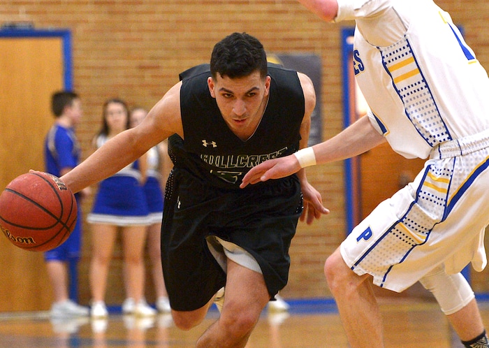 (Leah Hogsten | The Salt Lake Tribune) Hillcrest's Bassel Tekarli slips around Cyprus' Alex Foster. Cyprus High School boys' basketball team defeated Hillcrest High School 77-61 during their game Tuesday, January 30, 2018 in Magna.