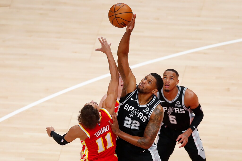 San Antonio Spurs forward Rudy Gay (22) battles Atlanta Hawks guard Trae Young (11) for a jump ball during the first half of an NBA basketball game on Friday, Feb. 12, 2021, in Atlanta. (AP Photo/Todd Kirkland)