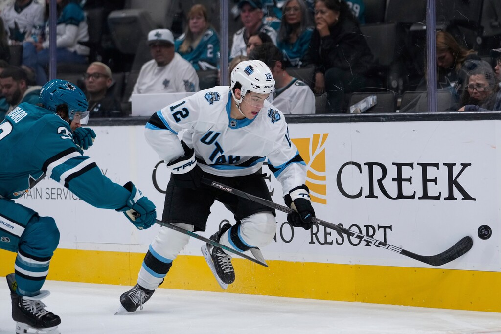 Utah Hockey Club forward Tij Iginla (12) moves the puck against San Jose Sharks defenseman Mario Ferraro during the second period of a pre-season NHL hockey game, Tuesday, Oct. 1, 2024, in San Jose, Calif. (AP Photo/Godofredo A. Vásquez)