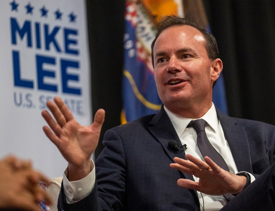 (Rick Egan | The Salt Lake Tribune) Utah Sen. Mike Lee makes a comment on stage with Tulsi Gabbard, during a rally in Draper, on Thursday, Oct. 27, 2022.