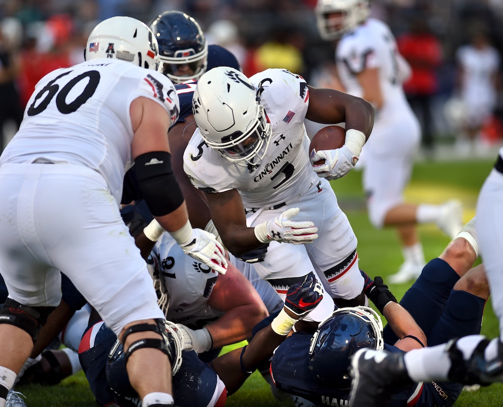 Cincinnati running back Tavion Thomas (5) runs the ball in for the team's sixth touchdown in the second half of an NCAA college football game against Connecticut, Saturday, Sept. 29, 2018, in East Hartford, Conn. Cincinnati won, 49-7. (AP Photo/Stephen Dunn)