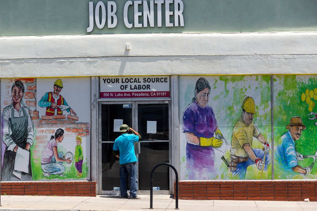 (Damian Dovarganes | AP file photo) In this May 7, 2020 photo, a person looks inside the closed doors of the Pasadena Community Job Center in Pasadena, Calif., during the coronavirus outbreak. On Thursday, Aug. 20, the government reported that the number of workers applying for unemployment climbed back over 1 million last week after two weeks of declines.