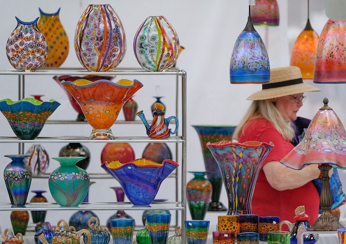 (Francisco Kjolseth  |  The Salt Lake Tribune)  Pamela Allred checks out the works by Hanson & Kastles during the annual 2019 Utah Arts Festival as it kicks off at Library Square and Washington Square in downtown Salt Lake City, Thursday, June 20, 2019, with visual and performance art of all varieties and food for all ages from June 20-23.
