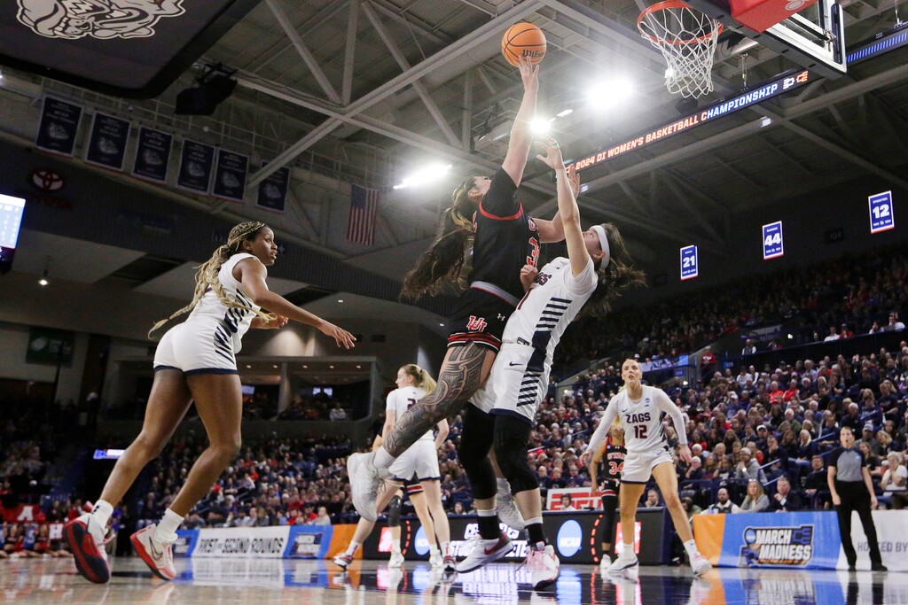(Young Kwak | AP) Utah forward Alissa Pili, center left, shoots while pressured by Gonzaga guard Kayleigh Truong during the first half of a second-round college basketball game in the NCAA Tournament in Spokane, Wash., Monday, March 25, 2024.