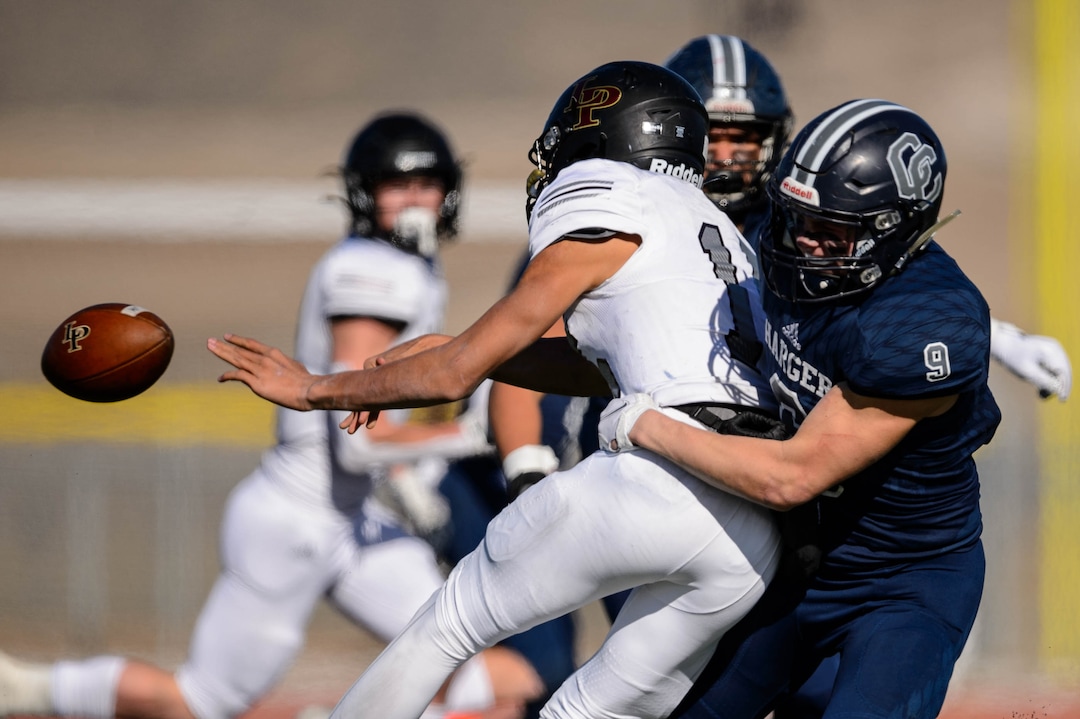 (Trent Nelson  |  The Salt Lake Tribune) Corner Canyon's Harrison Taggart hits Lone Peak's Jonah Heimuli during the 6A state football championship game at Cedar Valley High School in Eagle Mountain on Friday, Nov. 20, 2020.