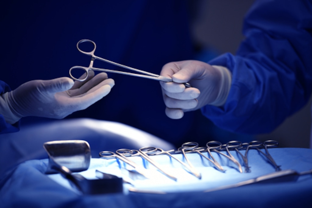 Surgeons are shown with a tray of surgical instruments. (The Associated Press)