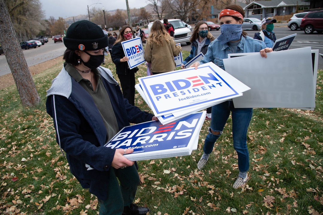 (Francisco Kjolseth  |  The Salt Lake Tribune) Anna Grossniklaus hands out signs to supporters of President-elect Joe Biden as they celebrate at Liberty Park on Saturday, Nov. 7, 2020, in Salt Lake City.