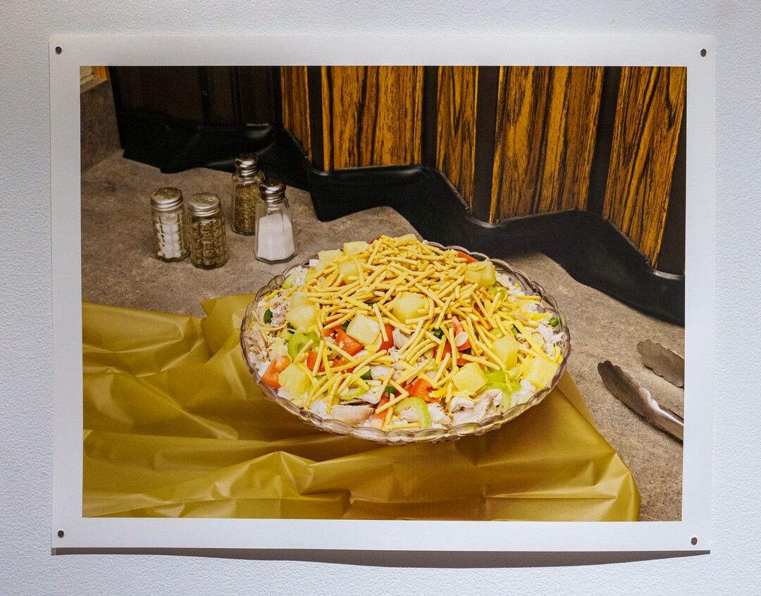 (Leah Hogsten | The Salt Lake Tribune) Doctrine #1 (FHaystack) Archival Pigment Print, 2021, from "Marrow" a photo exhibit by Daniel George at The Utah Museum of Contemporary Art, Sept. 3 2021. George examines the culinary and cultural heritage of members of The Church of Jesus Christ of Latter-day Saints. George recreated and photographed dishes from Ward Cookbooks, including Funeral Potatoes, Casseroles, Jello creations, turning food into folk art.