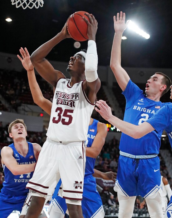 Mississippi State forward Aric Holman (35) shoots past the defense of Brigham Young guard Zac Seljaas (2) in the first half of an NCAA college basketball game in Starkville, Miss., Saturday, Dec. 29, 2018. (AP Photo/Rogelio V. Solis)