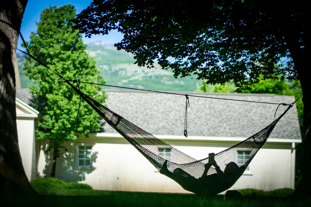 (Rick Egan | The Salt Lake Tribune) John Brown escapes the heat as he reads a book in the shade in Bountiful on June 3.
