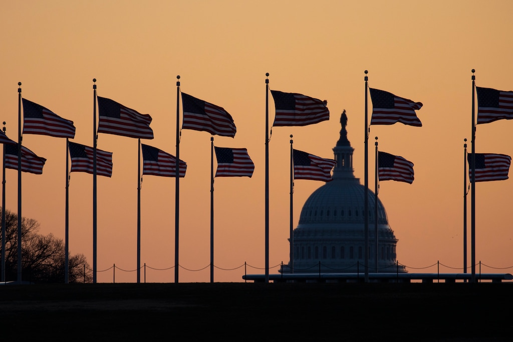 (Jon Elswick | AP) American flags blow in wind around the Washington Monument with the U.S. Capitol in the background at sunrise on Monday, Jan. 20, 2020, in Washington. The impeachment trial of President Donald Trump will resume in the U.S. Senate on Jan. 21.