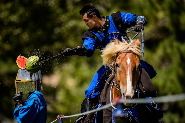 (Trent Nelson  |  The Salt Lake Tribune)  Edwin Brazzero slices a melon from a galloping horse as the Knights of Mayhem put on a jousting competition at the Utah Renaissance Faire at Thanksgiving Point in Lehi on Friday Aug. 23, 2019.