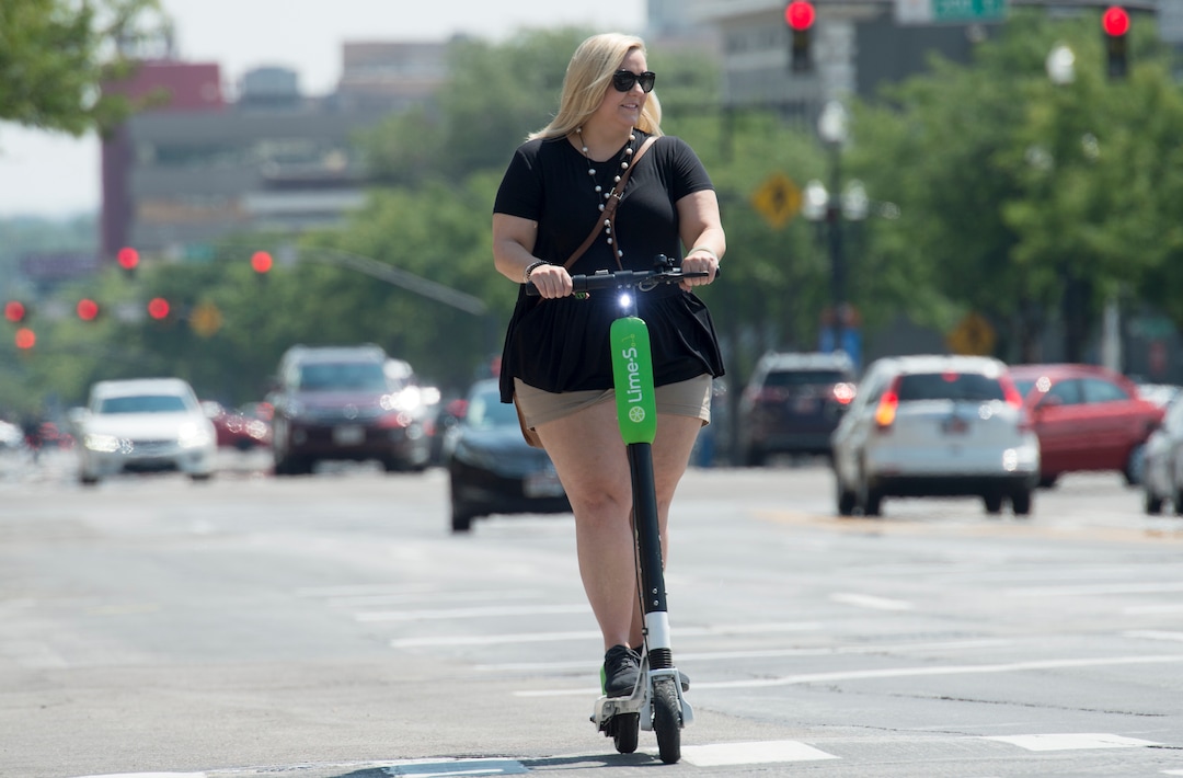 (Rick Egan  |  The Salt Lake Tribune)    Virginia Nist, visiting from Ansbach, Germany, rides a Lime Scooter on West Temple, in Salt Lake City, Monday, July 30, 2018.
