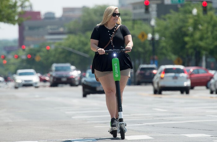 (Rick Egan  |  The Salt Lake Tribune)    Virginia Nist, visiting from Ansbach, Germany, rides a Lime Scooter on West Temple, in Salt Lake City, Monday, July 30, 2018.


