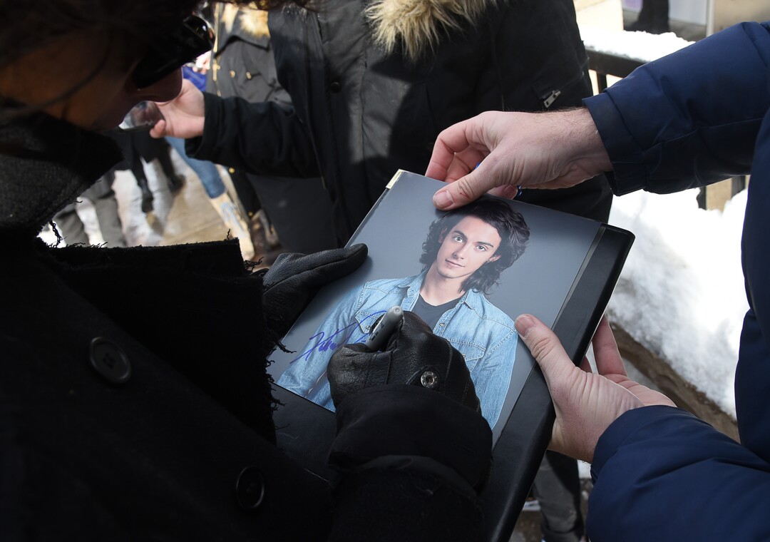 (Francisco Kjolseth  |  The Salt Lake Tribune) Xabiani Ponce de  León, who stars as a misfit teen in the Sundance film “This Is Not Berlin,” autographs photos of himself as the Sundance Film Festival kicks into high gear along Main street in Park City on Friday, Jan. 25, 2019.