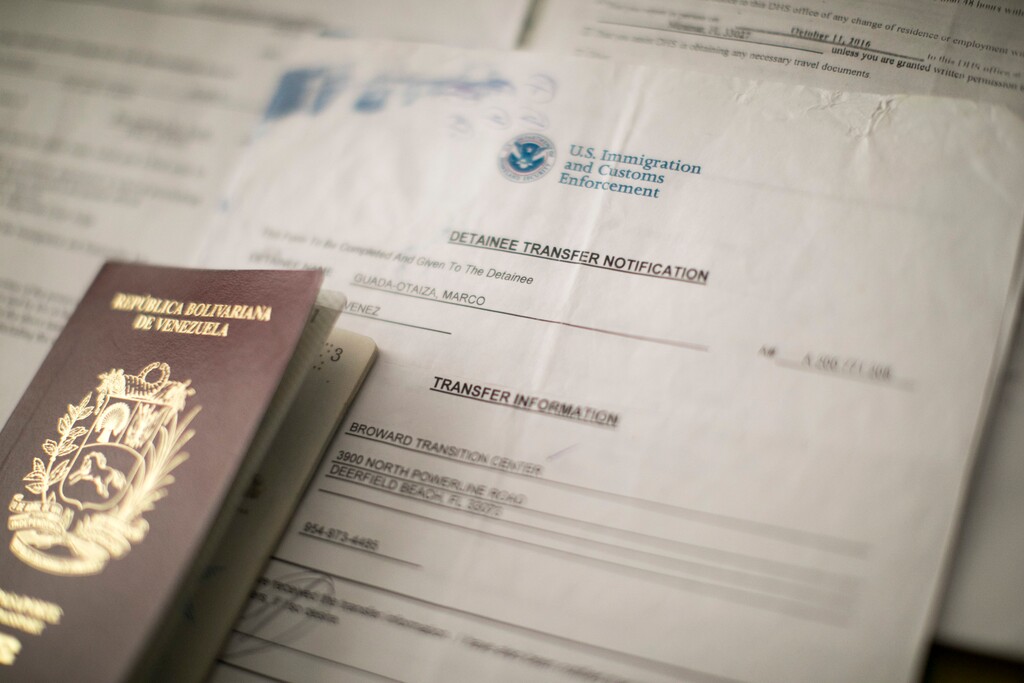 (Tatiana Fernandez | AP Photo) This Aug. 22, 2018 photo shows Marcos Guada's his transfer notification and passport inside his room at a hotel in Santiago de los Caballeros, Dominican Republic. Back in Venezuela this summer, Guada, now 50, wasn’t going to take any chances even if the immigration judge back in the U.S. didn’t think he was in imminent danger. In three days, he boarded a plane and flew to the Dominican Republic, where he is living with his son.