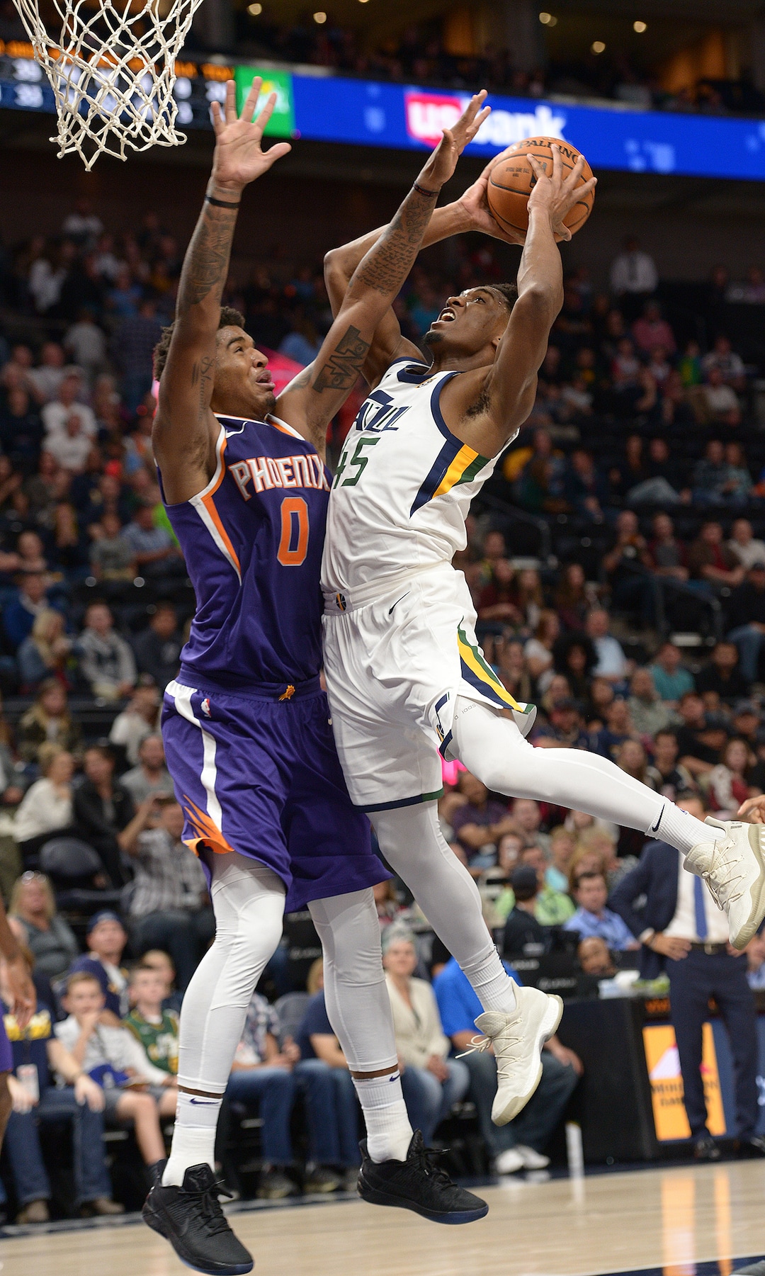(Leah Hogsten  |  The Salt Lake Tribune) Utah Jazz guard Donovan Mitchell (45) rounds Phoenix Suns forward Marquese Chriss (0) to hit the net. The Utah Jazz defeated the Phoenix Suns 112-101 during preseason NBA basketball at Vivint Smart Home Arena in Salt Lake City, October 6, 2017.