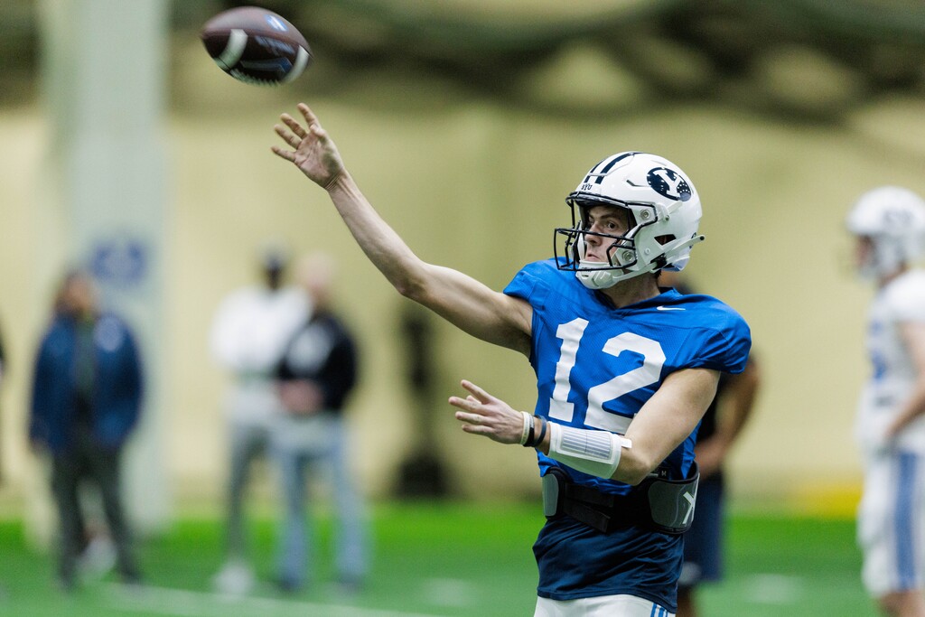 (Photo by Jaren Wilkey | BYU) Quarterback Jake Retzlaff attempts a pass in spring practice on March 10, 2023.