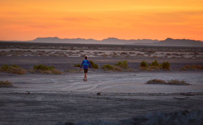 (Scott Sommerdorf | The Salt Lake Tribune)
Alex Doolan sets out on the last 3.8 miles as the sun rises at the Salt Flats 100 Endurance Run, Saturday, May 5, 2018. Doolan finished the race in 8th place.

