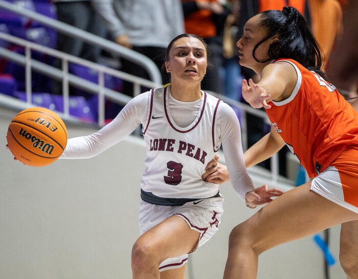 (Rick Egan | The Salt Lake Tribune)  Lone Peak guard Shawnee Nordstrom (3) tosses the ball around Merceius Mili (42) Skyridge, in the 6A girls Championship Game between Skyridge and Lone Peak, at Weber State, on Saturday, March 4, 2023.
