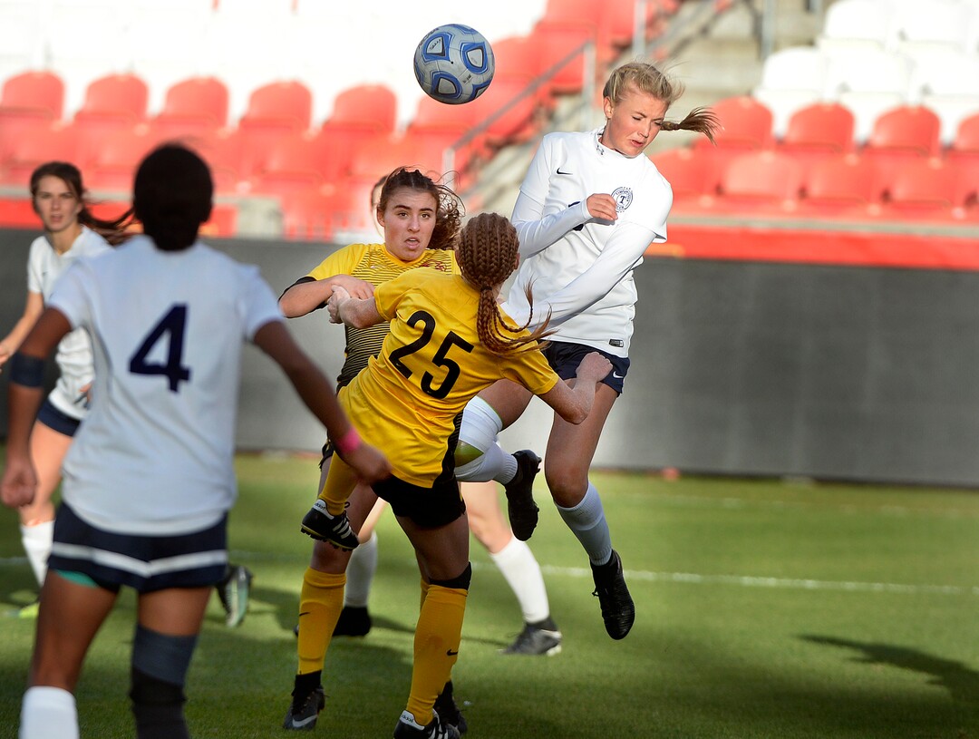 (Scott Sommerdorf   |  The Salt Lake Tribune)   Megan Unbedacht of Timpanogos, right, jumps to try to head a shot on goal during first half play. Maple Mountain won the shootout period after double overtime to win the 5A championship game over Timpanogos, Friday, October 20, 2017. 