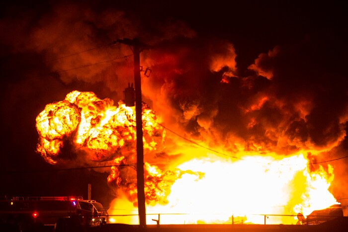 (Chris Detrick  |  The Salt Lake Tribune)  Firefighters attempt to put out a burning semitrailer that was hauling thousands of gallons of fuel on Interstate-15 in Midvale Thursday, January 18, 2018.   Lt. Todd Royce of the Utah Highway Patrol said the truck was southbound on the interstate at 7500 South at 7:20 p.m. when a tire caught fire, sending flames toward the tanks.